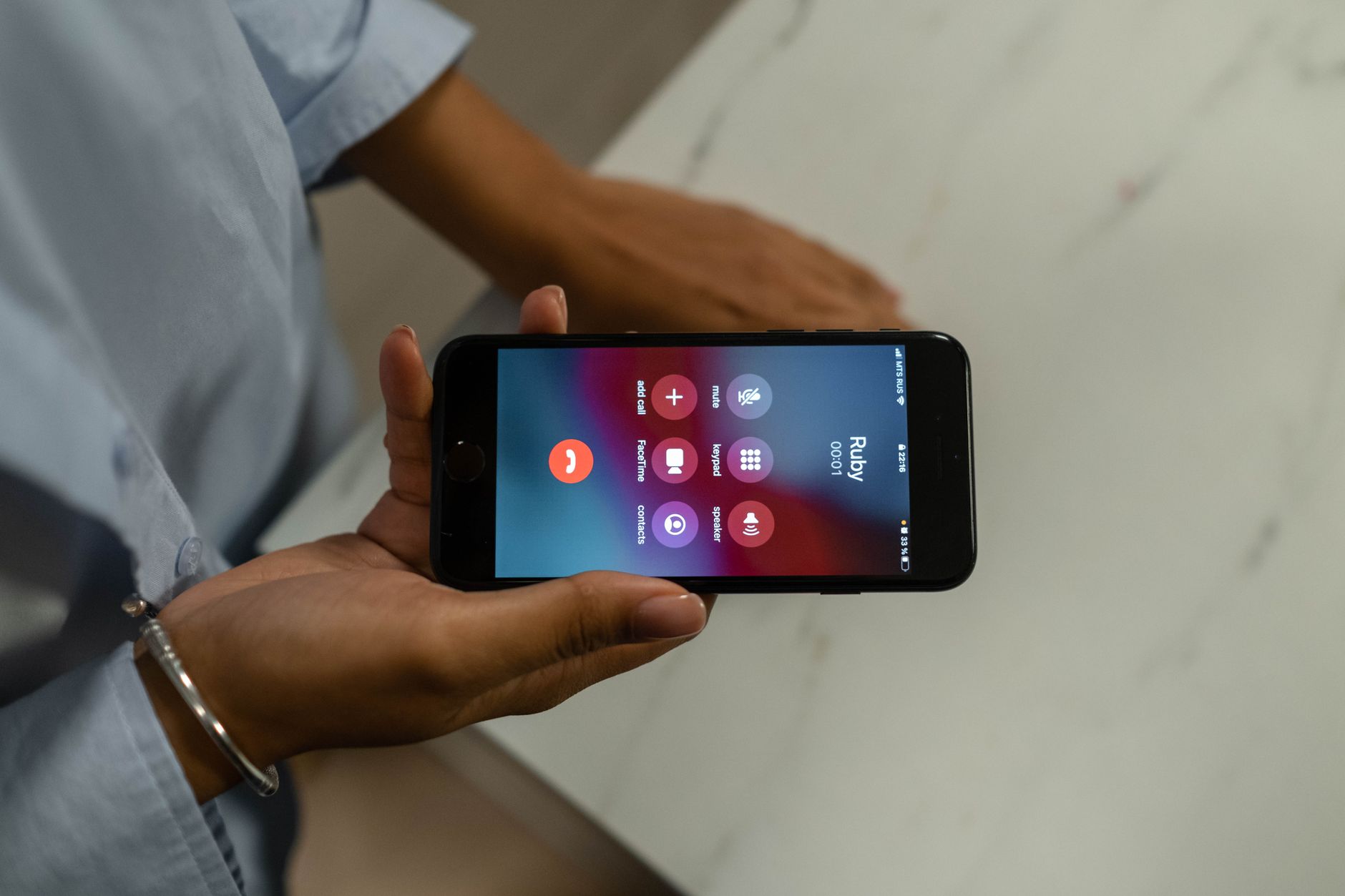 Always On Display - person picking up smartphone with lock screen showing time and notifications, real photo