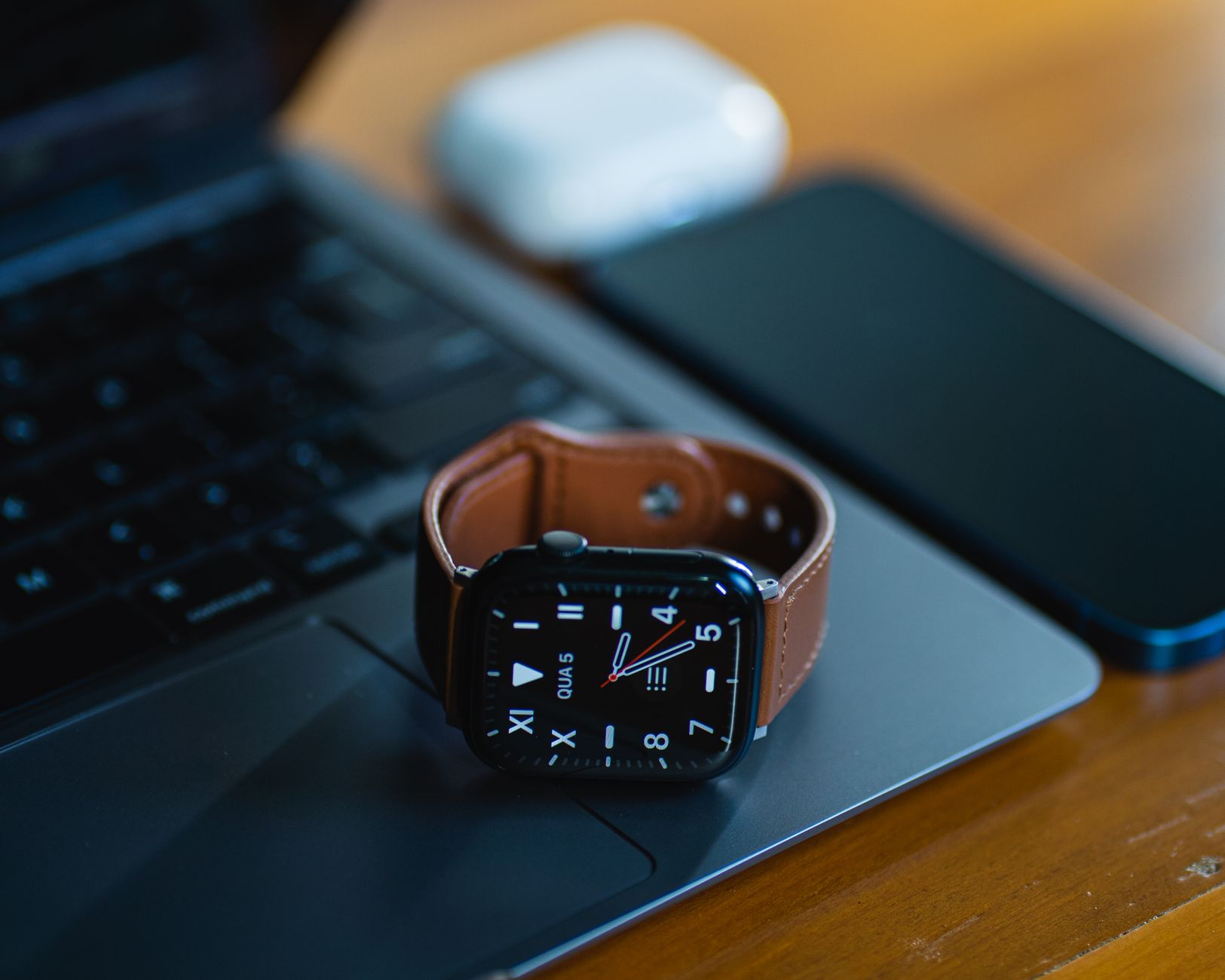 Always On Display - close up smartphone screen with always on display clock on wooden table, natural light